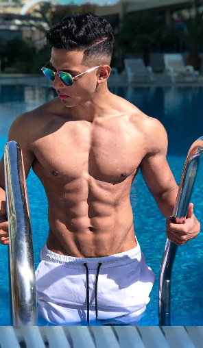 A shirtless picture of the coach coming out of the pool